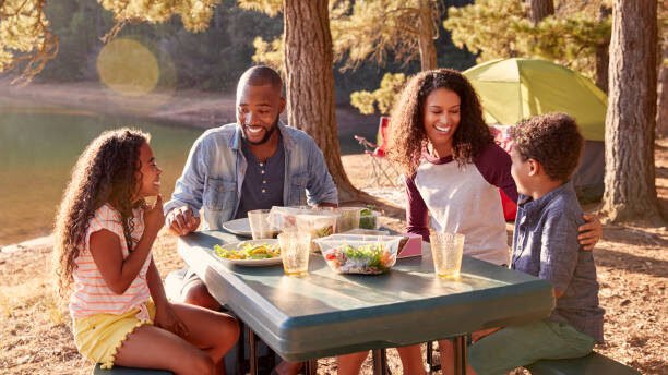 family doing mealing while camping